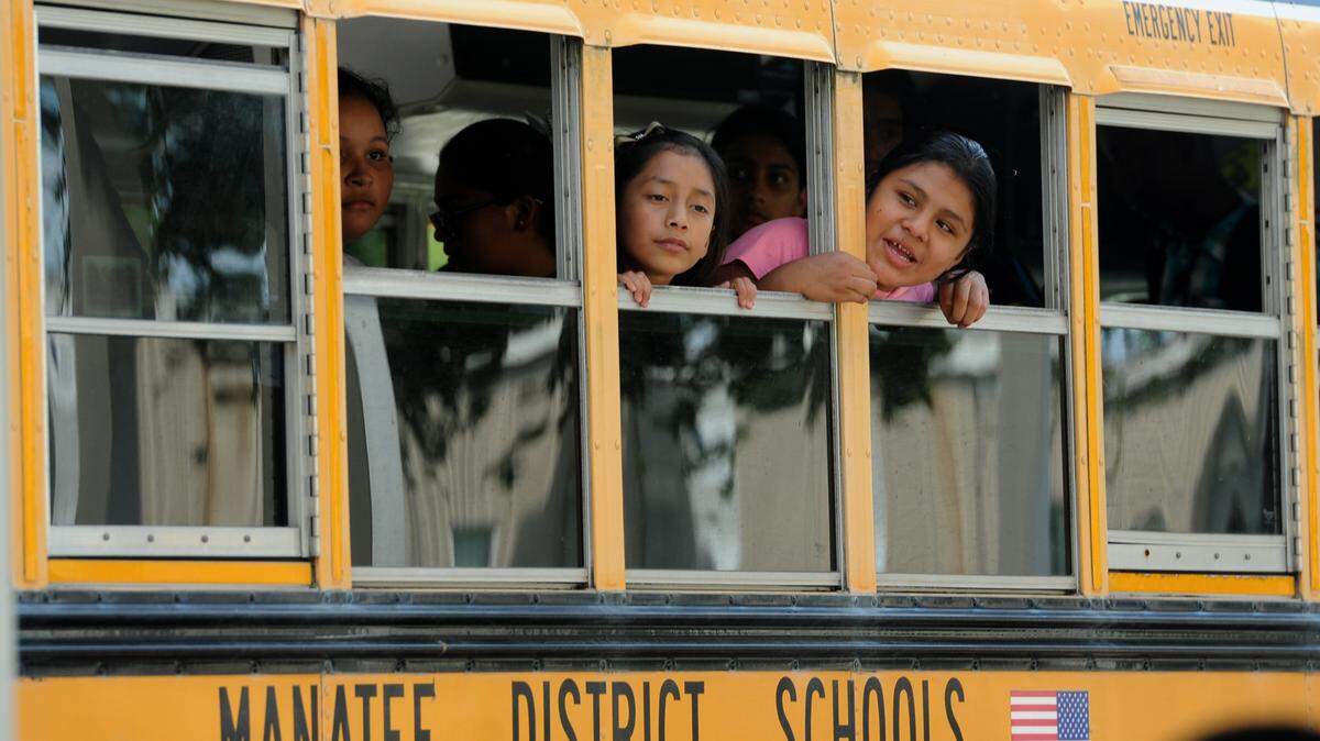 Students peer out of the windows of a Manatee County School District bus as it prepares leave King Middle School. File photo/
 GRANT JEFFERIES/Bradenton Herald