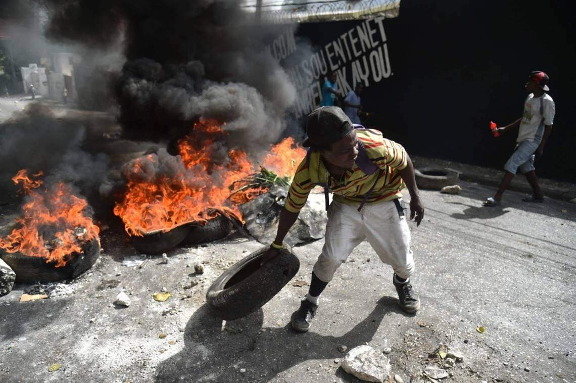 Protesters barricade a street in the Port-au-Prince suburb of Petionville on Saturday, July 7, 2018, to protest the increase in fuel prices.