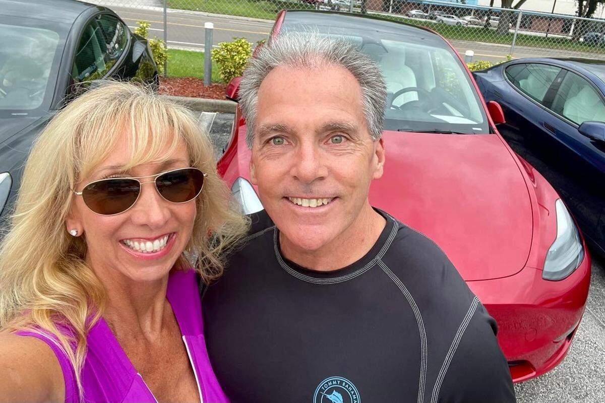 Carol Burdelik and her husband Michael stand in front of their new Tesla Y Performance. The couple decided to buy the car after test driving one at UTC mall and waited close to a year for the car to be built, Sept. 7, 2022.
