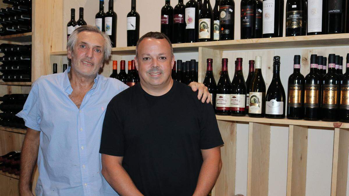 Lamantini Trattoria owner Perry E. Muphree Jr., left, and General Manager and Executive Chef Daniel Rabice stand in front of a portion of the restaurant’s wine selection.