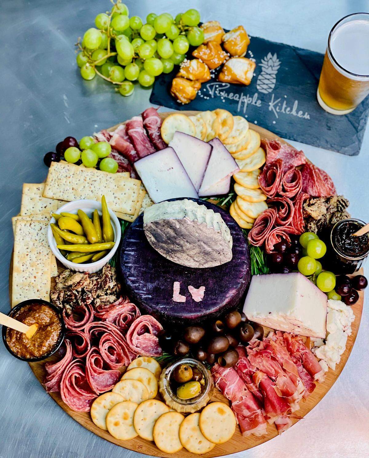 A Super Bowl LV Party Graze Board from Pineapple Kitchen in Bradenton serves 8-12 and features an edible centerpiece of gourmet cheeses, charcuterie meats, crackers, Mediterranean olives, jam and mustard, chocolate espresso beans and more.