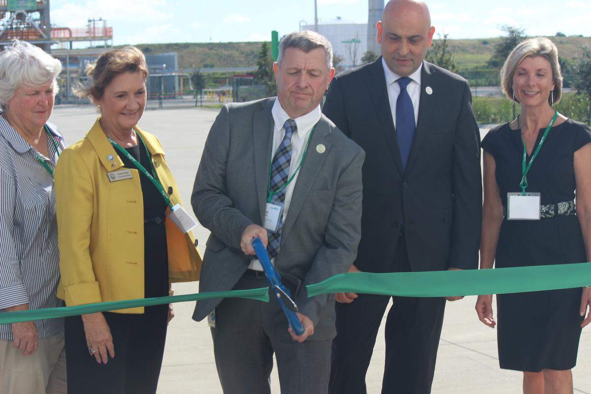 Air Products plant manager Mark Evans cuts the ribbon for the company’s  new liquefied natural gas equipment test facility near Port Manatee on Thursday. Also shown, from left, are Priscilla Whisenant Trace, Vanessa Baugh, Samir Serhan, and Sharon Hillstrom.