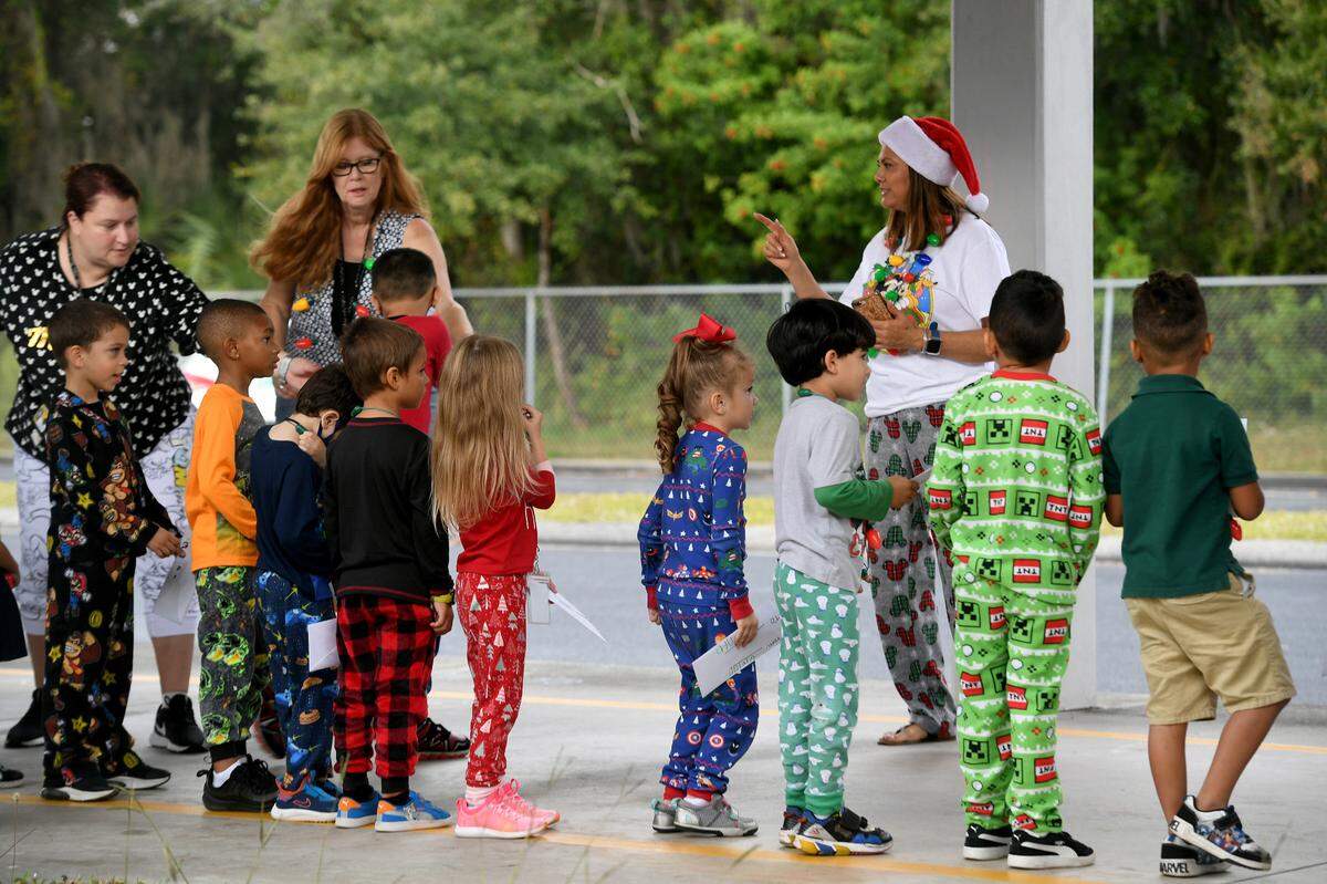 12/20/21—Children line up for the arrival of Santa, who came on an East Manatee Fire Rescue truck at Bashaw Elementary School.