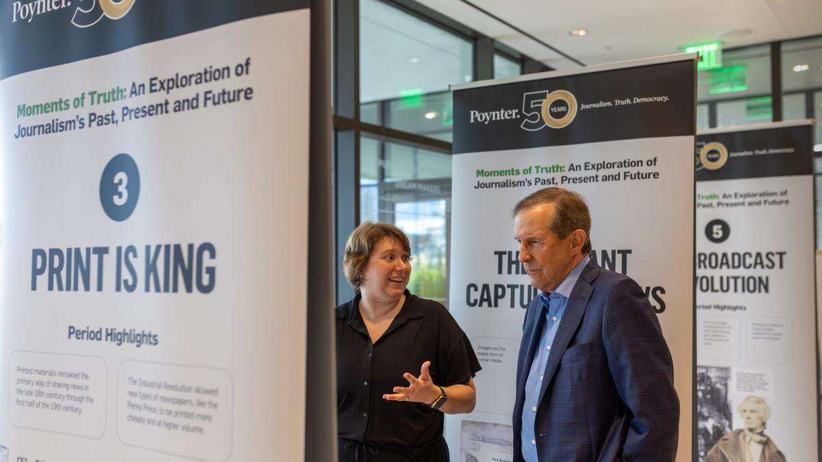People visit the “Moments of Truth: An Exploration of Journalism’s Past, Present and Future” exhibit.