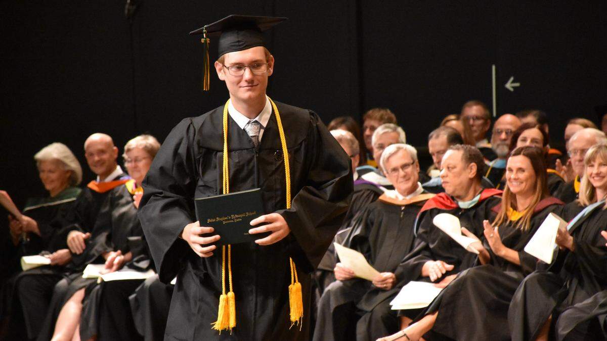 Jacob David Eyre walks across the stage with his high school diploma during the Saint Stephen’s Episcopal School 2019 ceremony at the State College of Florida’s Neel Performing Arts Center on Saturday morning.