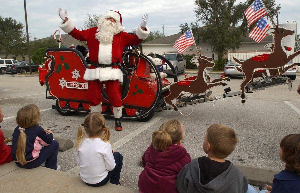 Santa Claus (aka Dick Verzone) and other residents from Horseshoe Cove visited the Easter Seals Child Development Center Friday morning. Santa and his crew arrived at the center riding in decorated golf carts, 2004.