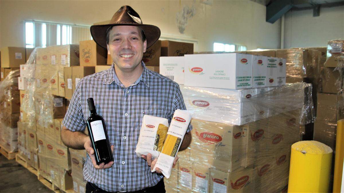 Sergio Francone is shown with some of the wine and pasta products he imports through the International Trade Hub at Port Manatee.