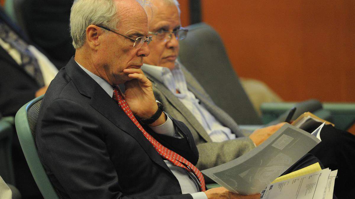 Developer Pat Neal looks over paperwork as he attends a meeting of the Manatee County School Board as it addresses impact fees Tuesday. 
 GRANT JEFFERIES/Bradenton Herald