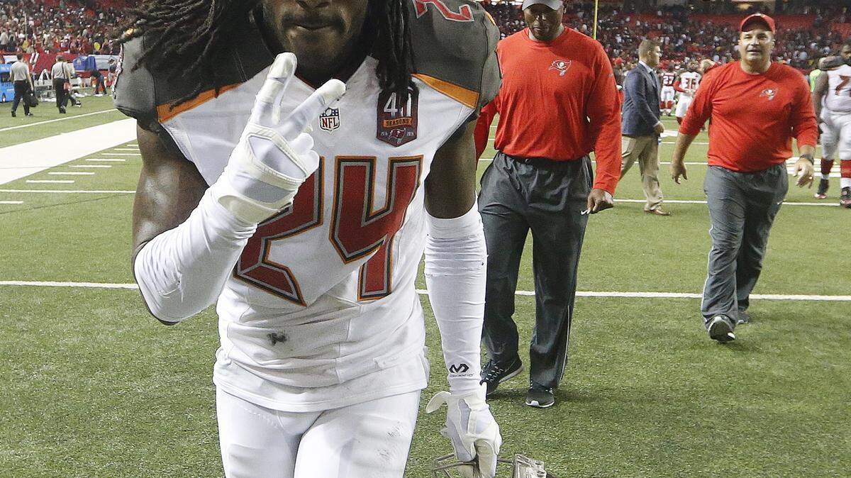 Buccaneers cornerback Mike Jenkins walks off the field after defeating the Falcons last week in Atlanta. ASSOCIATED PRESS