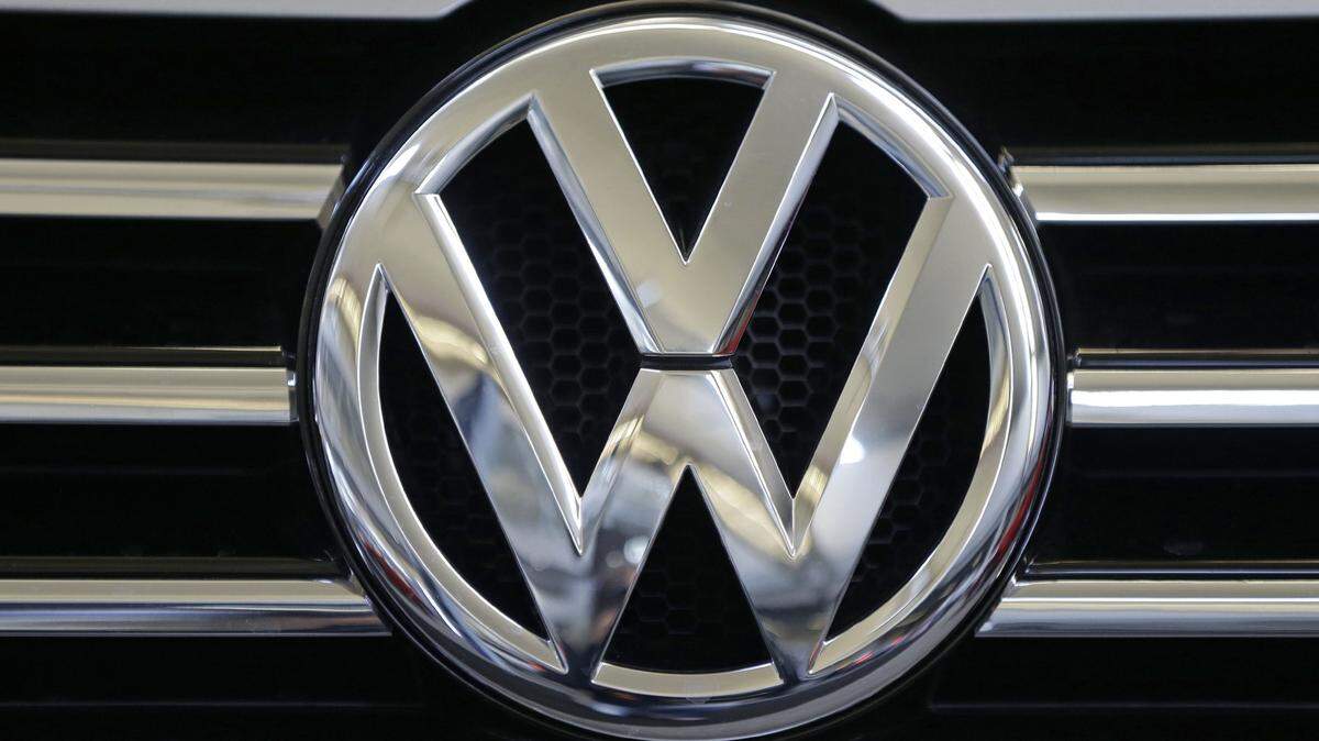 FILE - In this Feb. 14, 2013, file photo, the Volkswagen logo is seen on the grill of a Volkswagen on display in Pittsburgh. A person briefed on the matter said Wednesday, April 20, 2016, that Volkswagen has reached an agreement with the U.S. government to spend just over $1 billion to compensate owners of diesel-powered cars that cheat on emissions tests. (AP Photo/Gene J. Puskar, File)