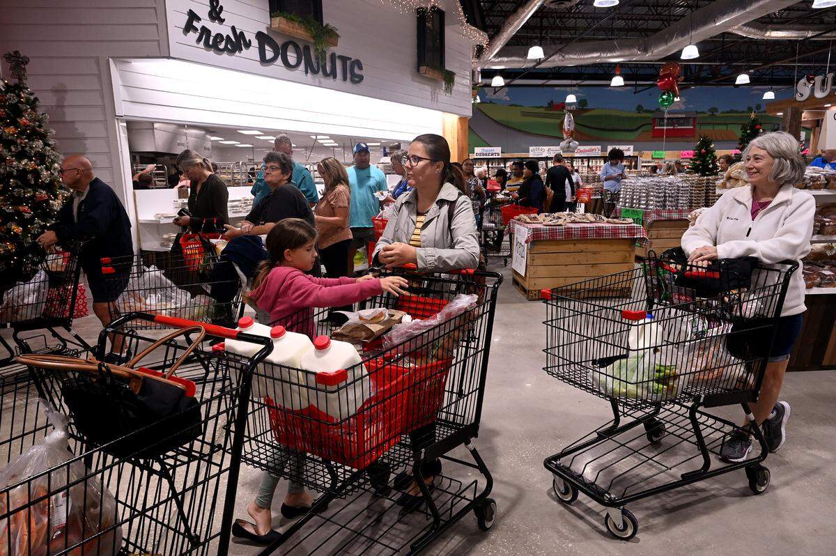 Customers shop at the grand opening of the newest Detwiler’s Farm Market store in Bradenton.