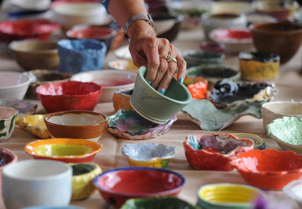 Nancy Luse looks at a hand-crafted bowl during the 15th annual Empty Bowls luncheon at Renaissance on 9th. Proceeds from the luncheon benefit the Food Bank of Manatee.