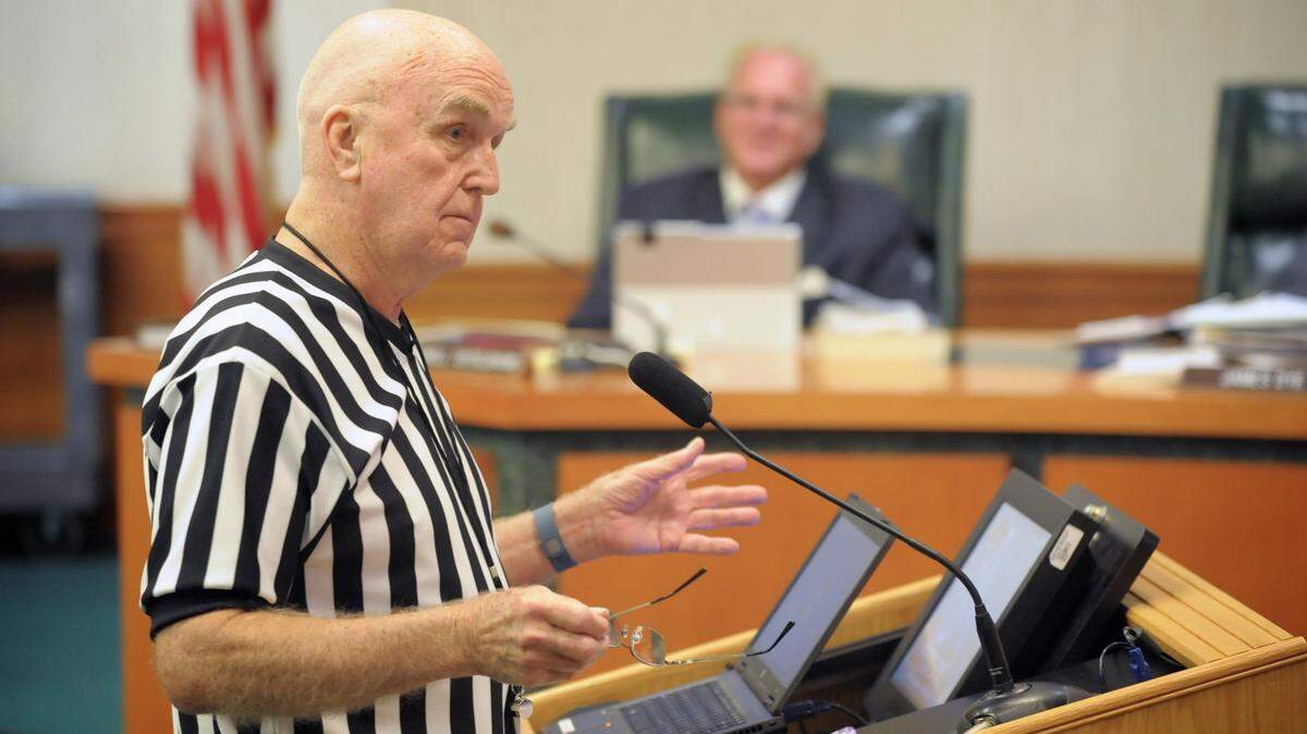 Bradenton resident Norm Nelson, then 83, wears a referee shirt and whistle as he addresses members of the Manatee County School Board in 2015.