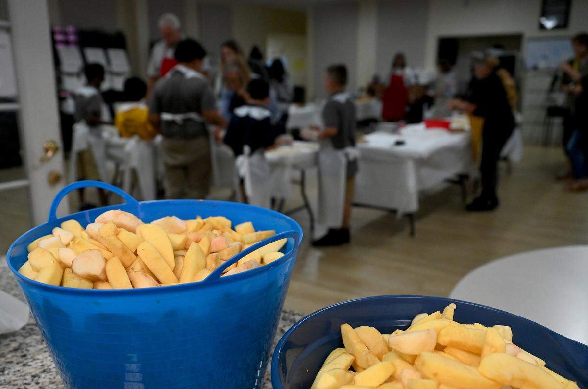 Students make apple pies for their families’ Thanksgiving celebrations at Visible Men Academy on Friday, Nov. 17, 2023.