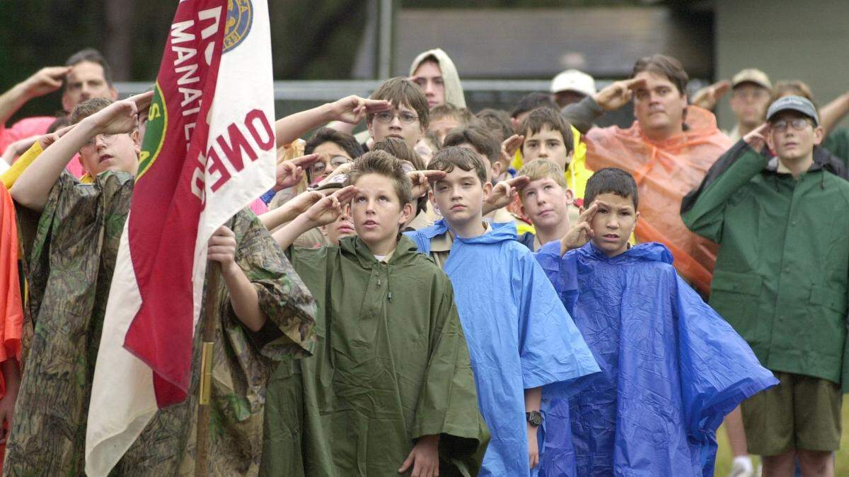 Scouts salute during the opening ceremonies of the 2001 Manatee District Camporee, as over five hundred scouts from Manatee County gathered at Camp Flying Eagle for the weekend.