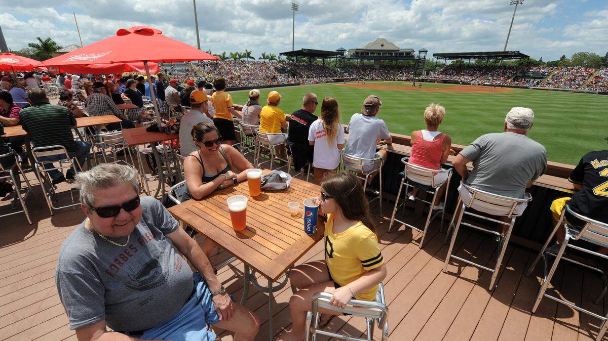 Barrett Greenlee and his daughter, Paige Greenlee, and her niece, Felicity Bracco, and other baseball fans pack McKechnie Field as the Pittsburgh Pirates host the Boston Red Sox during a spring training game Wednesday in Bradenton. McKechnie Field was the number one choice by readers of Ballpark Digest and Spring Training Online websites for the best Grapefruit League spring-training ballpark during a recent polling. 
 GRANT JEFFERIES/Bradenton Herald