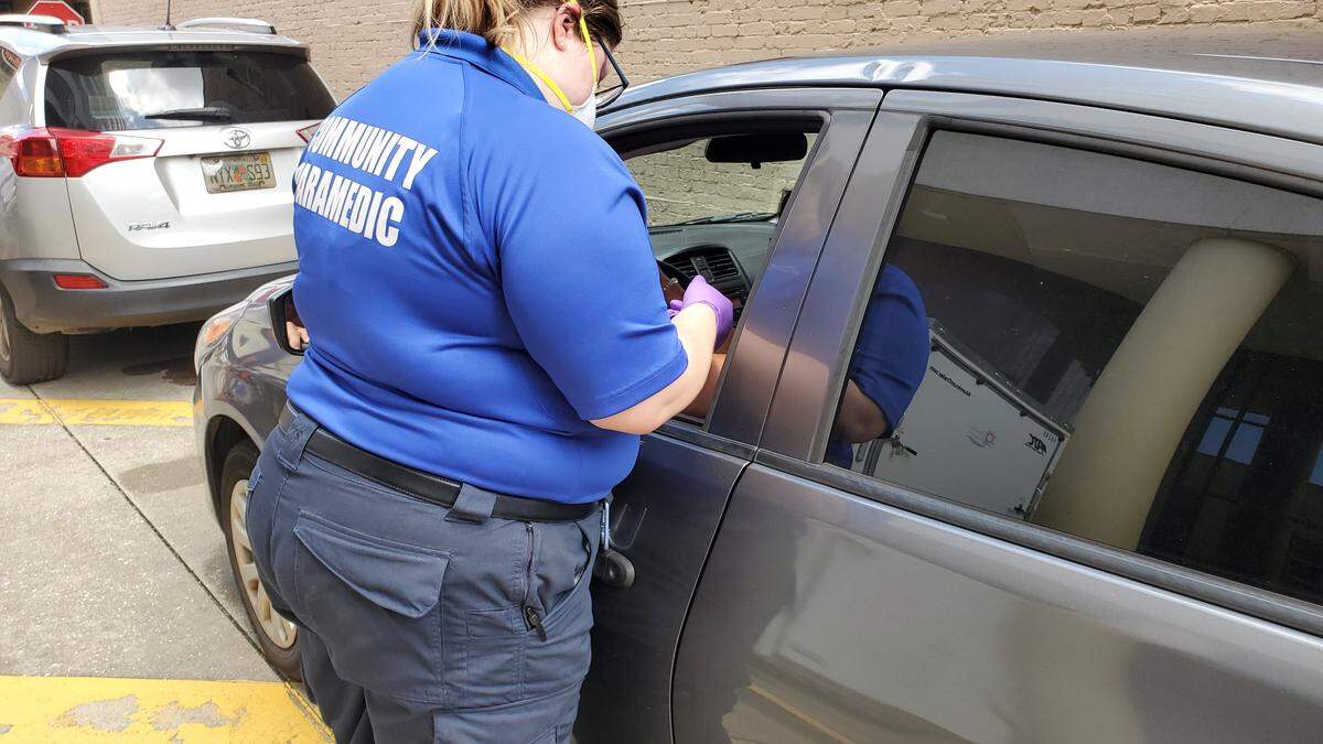 A community paramedic administers the Johnson & Johnson vaccine to Jessica Bowles at a drive-thru vaccine event held in downtown Bradenton on Friday.
