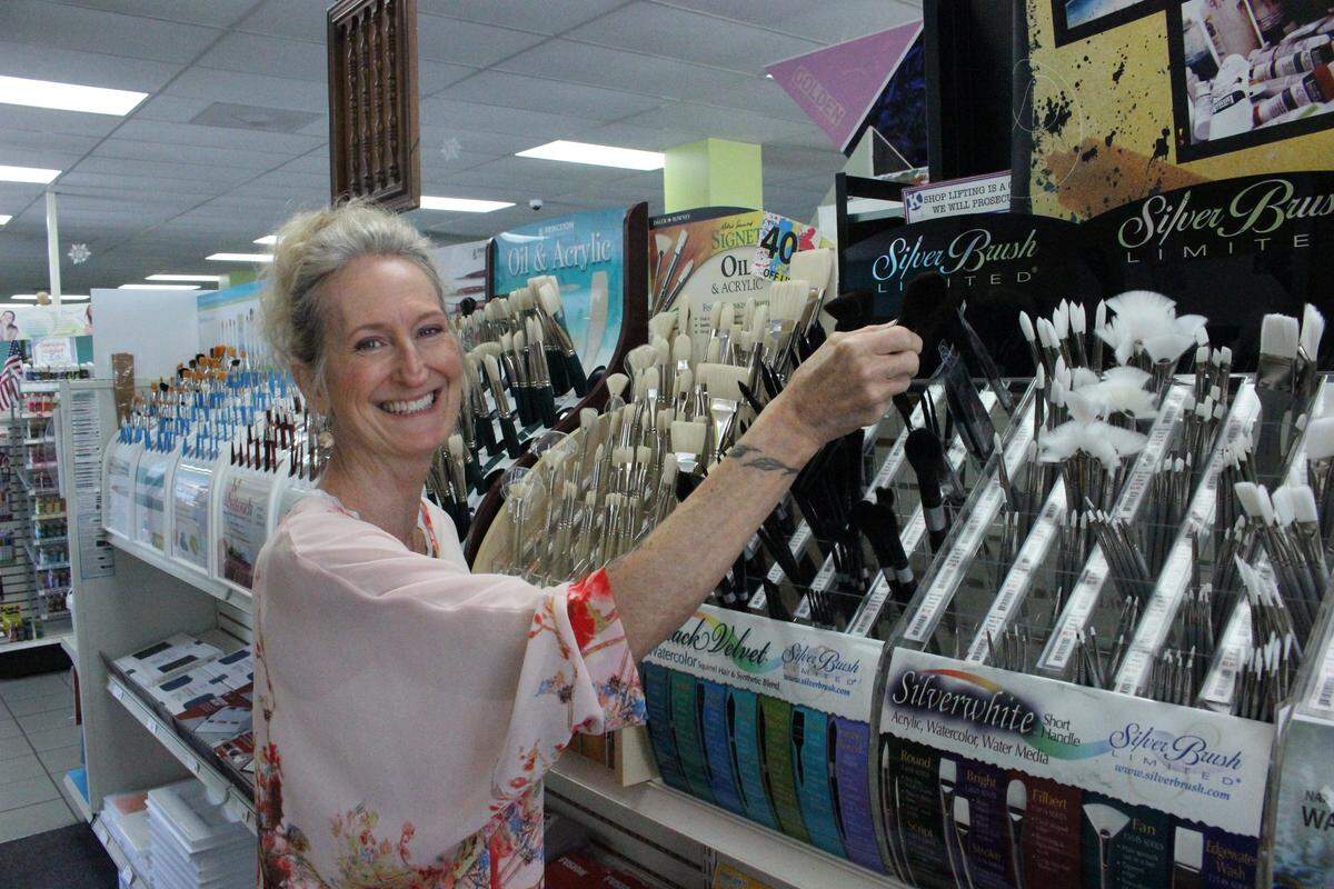 Sandy Barry looks through a selection of paint brushes at Creative Art Supply at 817 Manatee Ave. W., Bradenton.
