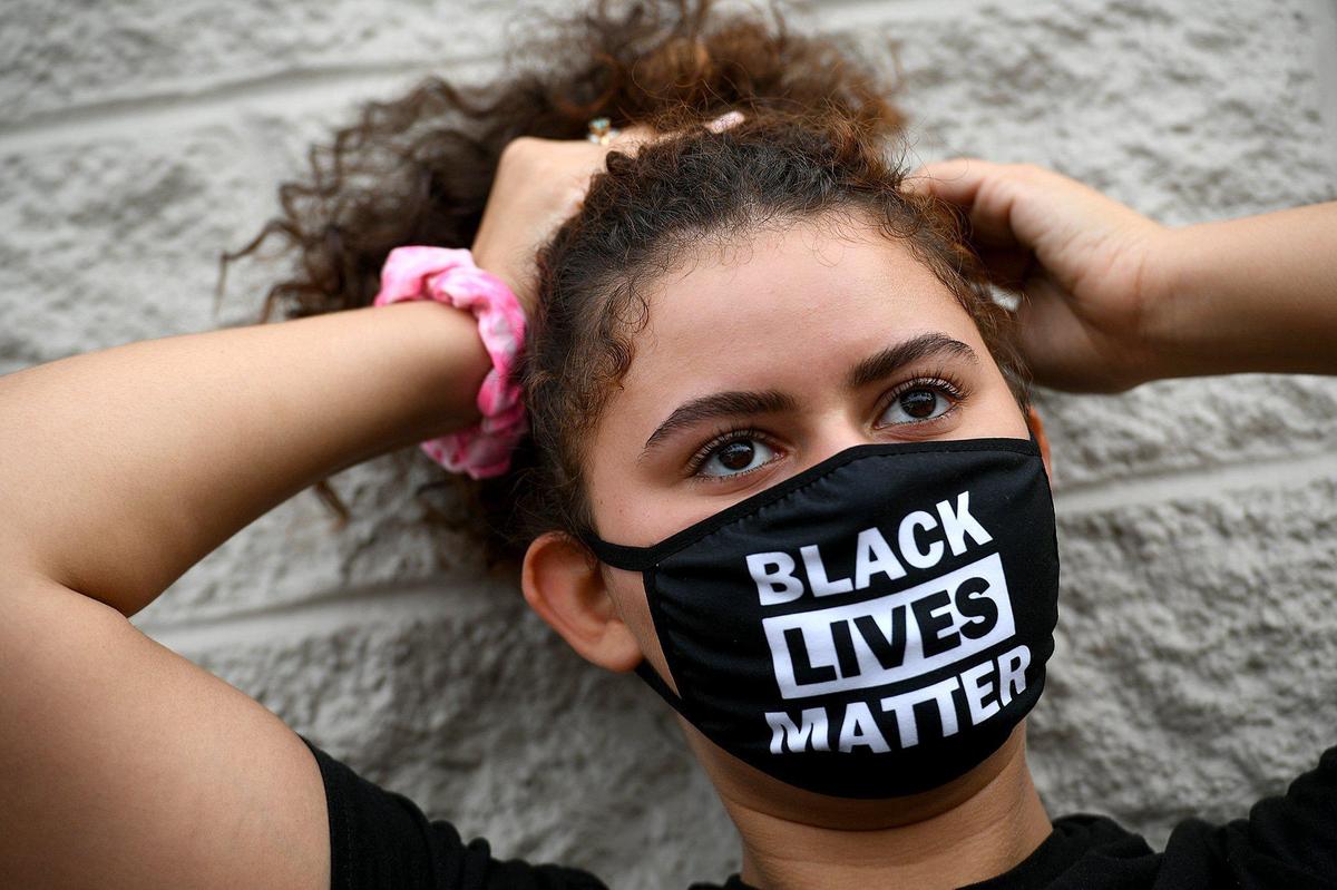 Mari Rothstein gets ready before a Black Lives Matter Sarasota-Manatee Alliance protest march in Bradenton.