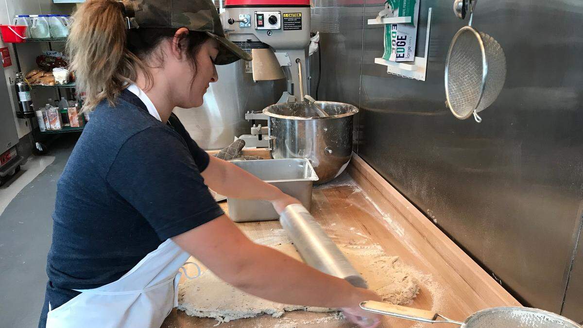 Angel Bizich rolls out biscuit dough at Maple Street Biscuit Company, 8491 Cooper Creek Blvd., unit 107, in University Park.