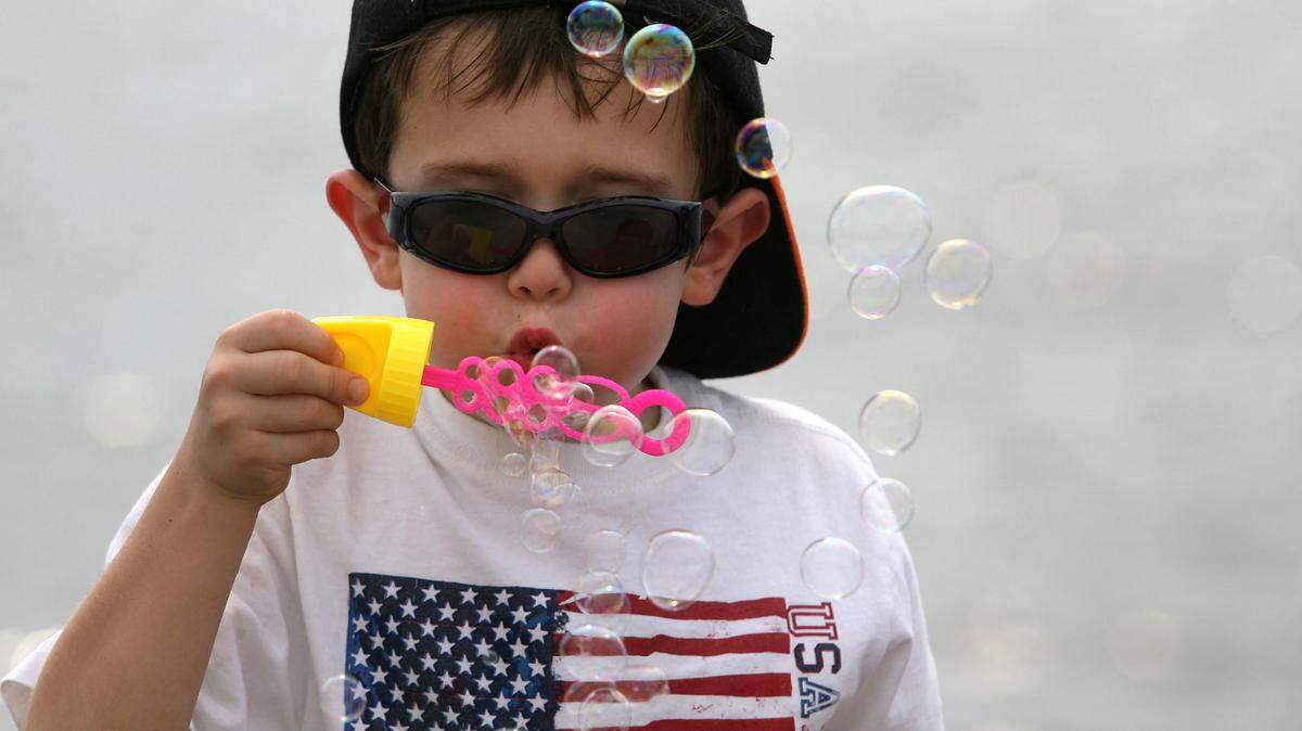 Thomas Gabriel blows bubbles in the breeze on Palmetto’s riverfront during a past Fourth of July celebration.