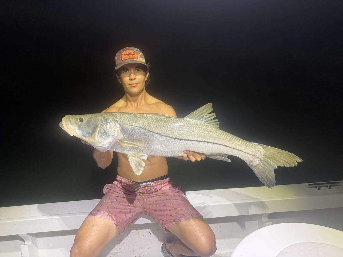 A member of Team Shrimpin Ain’t Easy poses with one of their tournament-winning snook. The team turned in four snook totaling 161 inches to win first place.