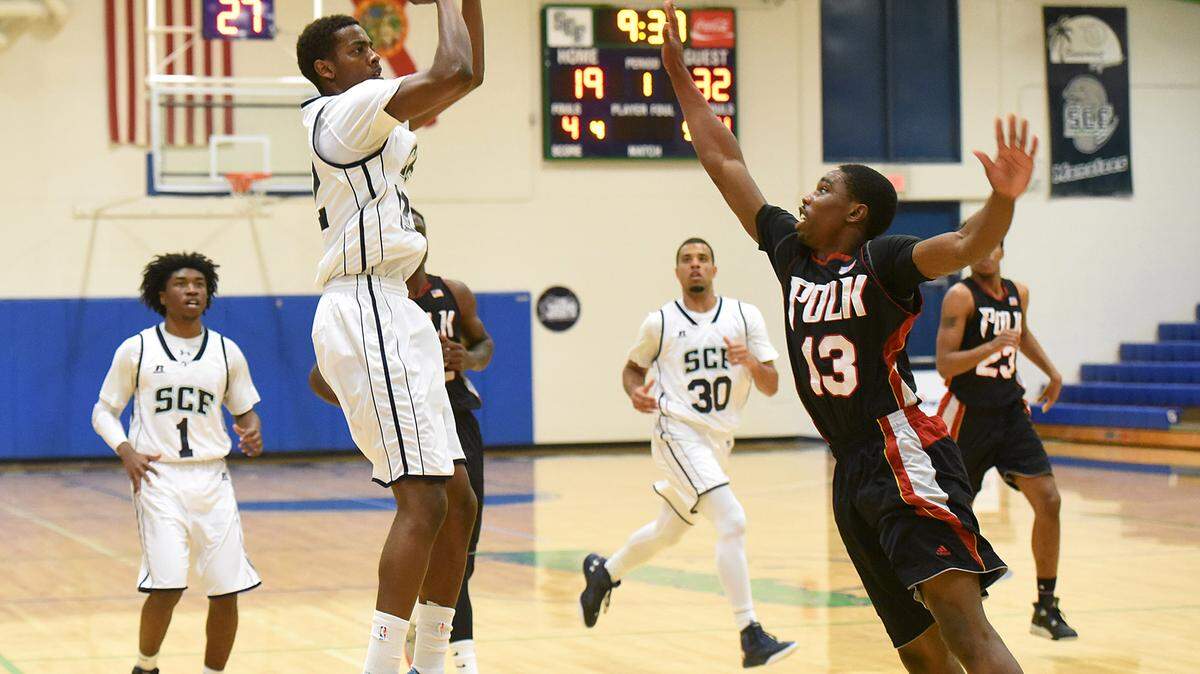 State College of Florida's Rahim Williams shoots over a Polk State College defender on Saturday in Bradenton.Photos by TIFFANY TOMPKINS/Bradenton Herald