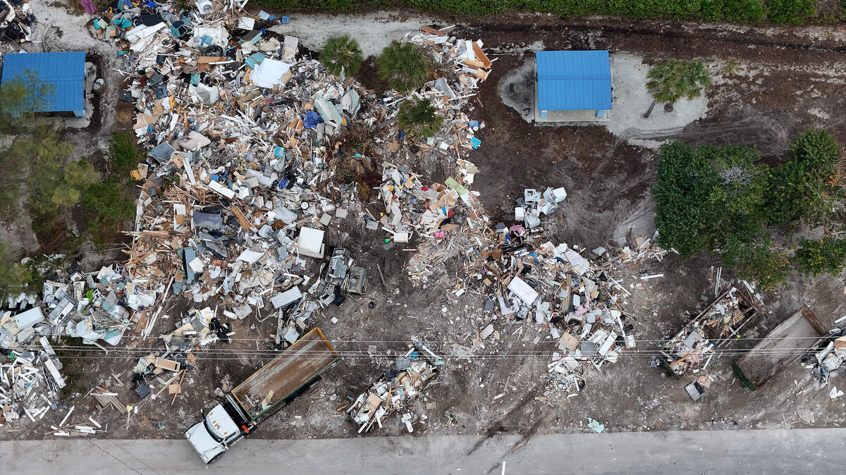 A massive amount of storm debris is stacked on N. Bay Drive on Anna Maria Island where dump trucks come haul away loads as Hurricane Milton approaches Manatee County on Oct. 8, 2024.