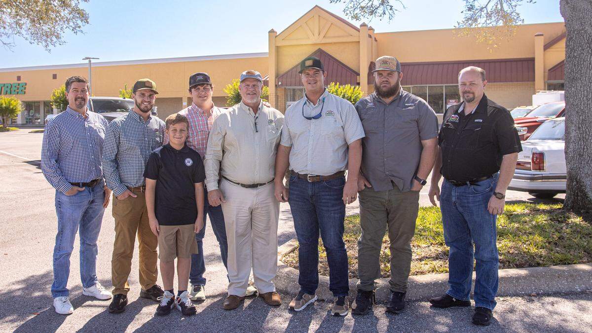 Steve Schlabach, Henry Detwiler Jr., Wyatt Detwiler, Josh Detwiler, Henry Detwiler Sr., Sam Detwiler, Caleb Detwiler and Mike Asher are shown in front of the west Bradenton shopping center where their sixth store is planned.