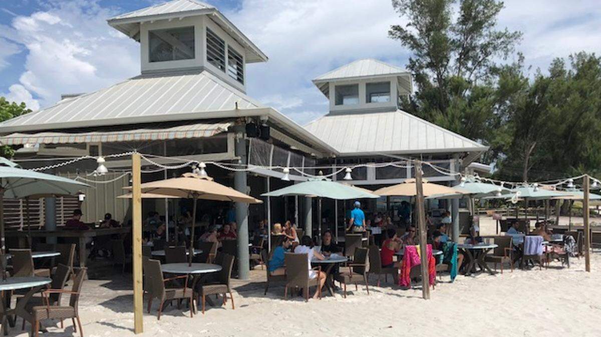 The Sandbar Restaurant, on Anna Maria Island, has taken a big financial hit after red tide swarmed local beaches. The restaurant’s outdoor seating area was about one-third empty Sunday afternoon and the beach in front of the restaurant was almost empty.