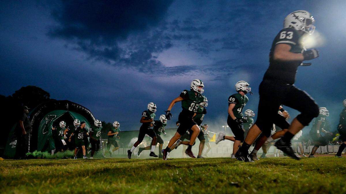 Lakewood Ranch makes their entrance through a tunnel to play Manatee at Lakewood Ranch stadium on Friday, Sept. 29, 2023.