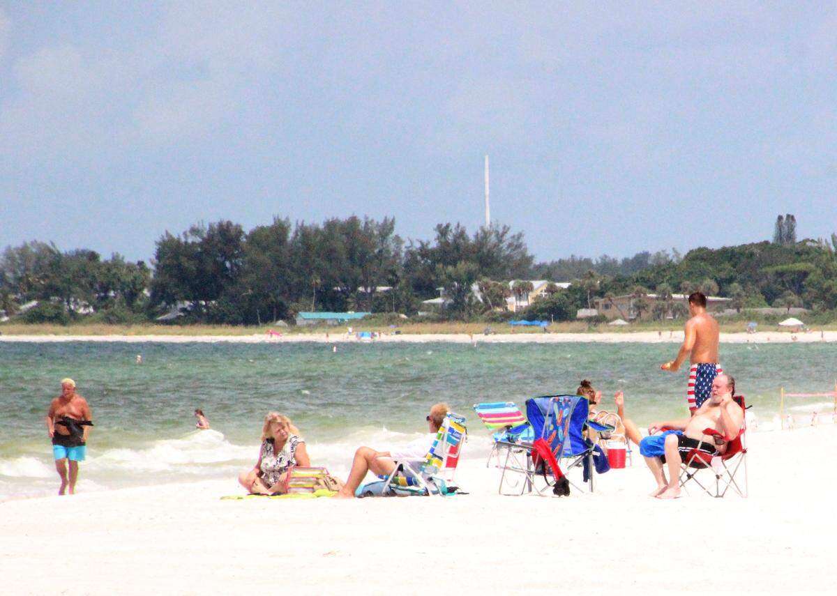 More beach goers were seen Monday on Anna Maria Island north of State Road 64, where the effects of red tide were weaker than further south.