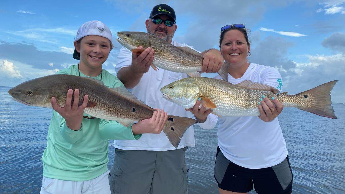 Bryson, Justin and Erica Rupert show off fish they caught while fishing with Captain Griffin Deans this past week in Tampa Bay.