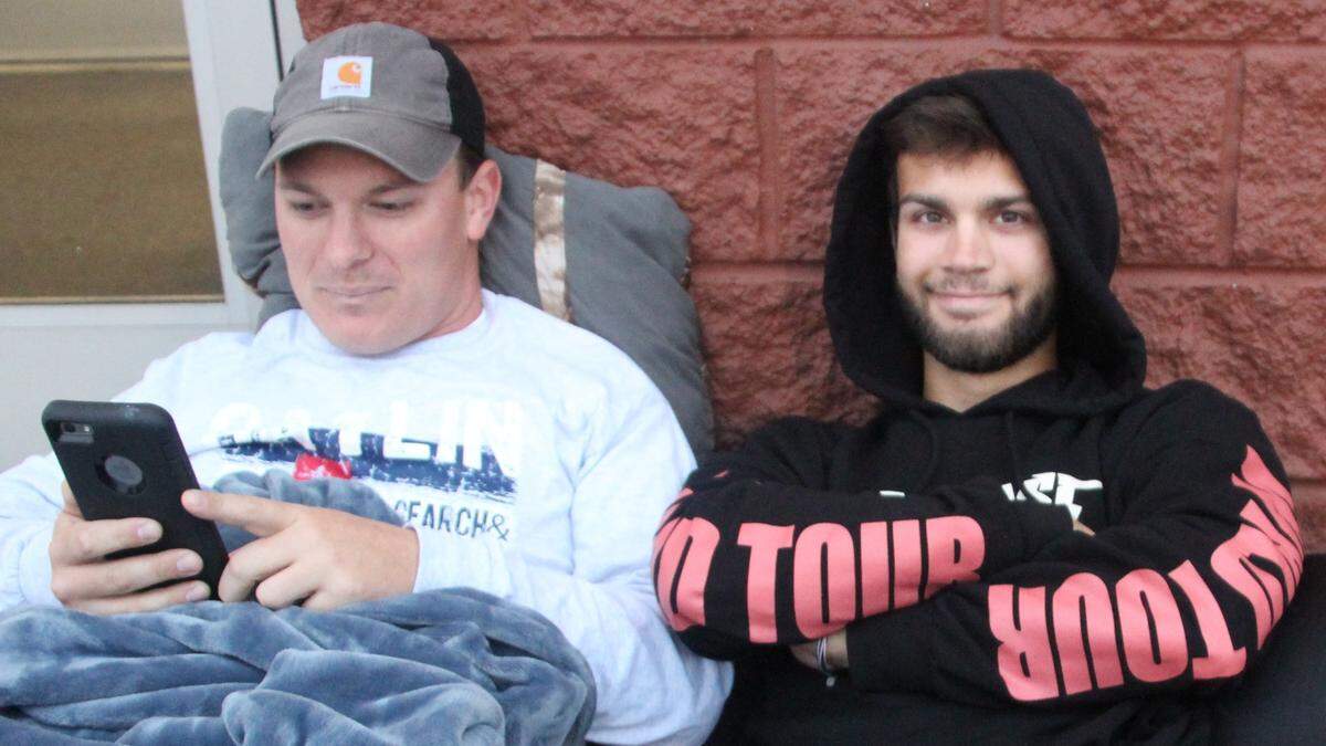 In 2017, Josh France, left, and Logan Gonzalez camped outside Office Depot, waiting for the store to open to take advantage of a dwal on a laptop computer.