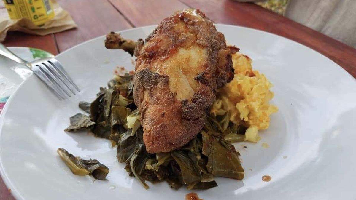Fried chicken breast is served with mac and cheese, and collard greens at Cottonmouth Southern Soul Kitchen, 1114 12th St. W., in Village of the Arts.