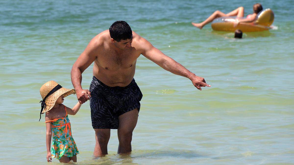 Enrique Rivera and daughter, Lexee, 4, play in the water at Coquina Beach on Anna Maria Island in this file photo.