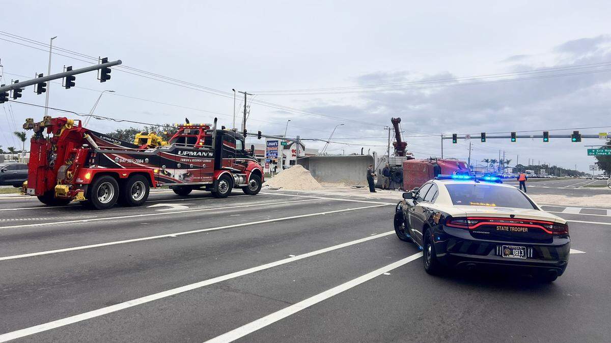 Emergency crews with Florida Highway Patrol clear the area after a semi-truck rollover at the intersection of U.S. 301 and Old Tampa Road in Parrish on Friday, Dec. 22, 2023.