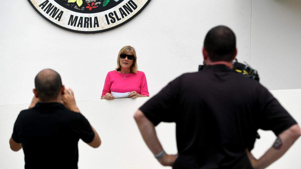 Manatee County Commissioner Carol Whitmore makes a statement outside the Holmes Beach Police station where she says she turned in campaign signs from a challenger that she believed were illegally placed.