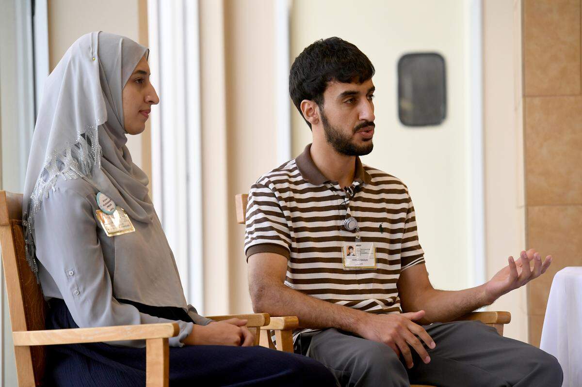Noman Raoufi and his sister, Venus, at Westminster where they both now work after immigrating from Afghanistan.