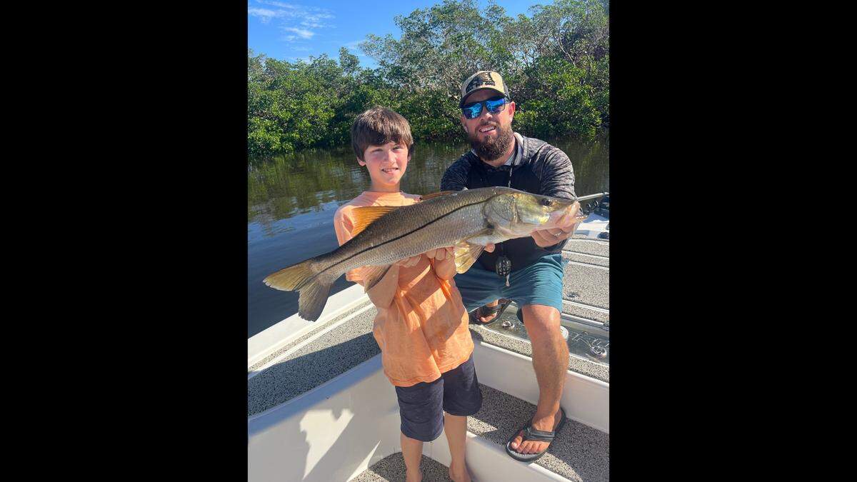 Captain Todd Young and 13-year-old angler Stash, who caught a 30-inch snook fishing the south shore of Tampa Bay.