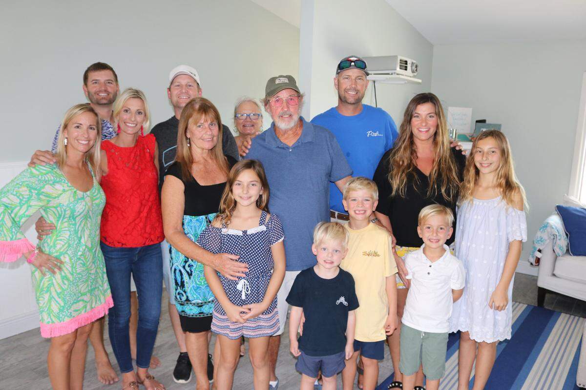Charter boat captain Scott Moore, left, got the surprise news at home this week that he had been selected for the Manatee County Agricultural Hall of Fame in recognition of decades of environmental conservation work. His large family was on hand for the announcement. Shown above, from left, front, are June Moore, Benjamin Guth, Kellan Hunt, Jase Moore, and Jordan Moore, second row, Kelly Hunt, Katie Guth, Karen Moore, Scott Moore, Justine Moore, Jenny Moore, third row, Courtland Hunt, Ben Guth, and Sandy Wooten.