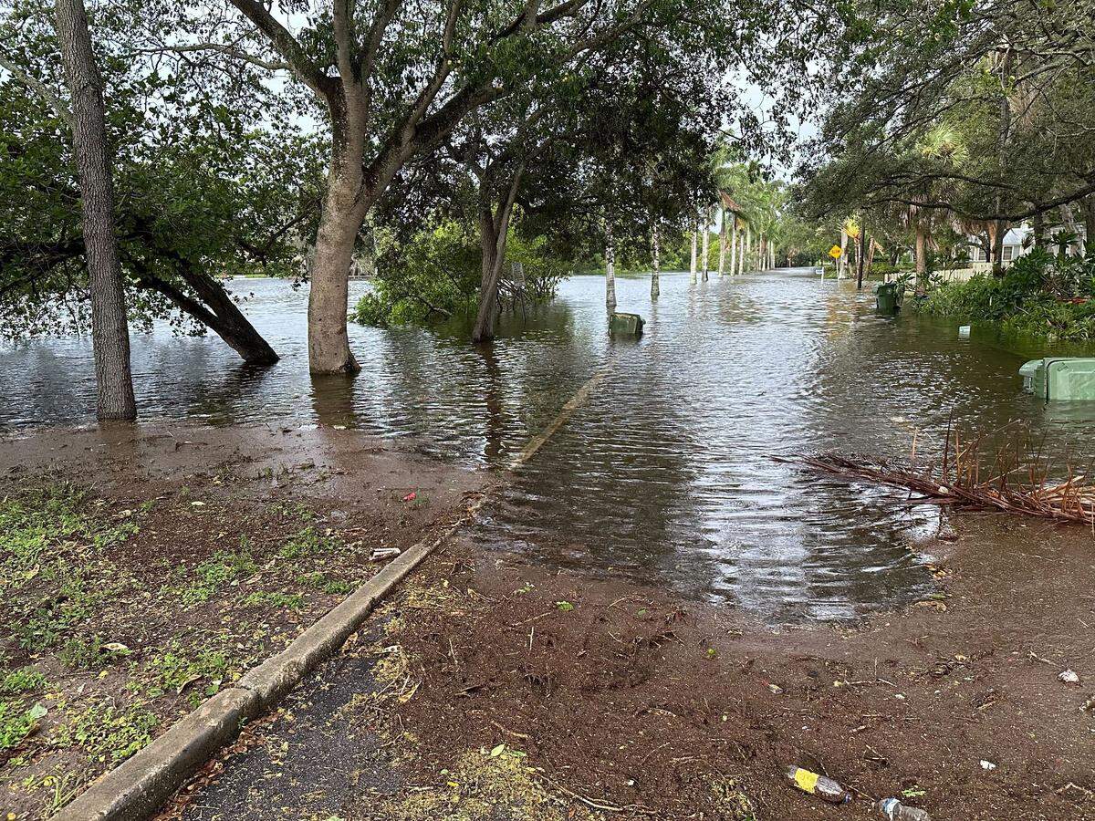 City of Bradenton workers closed parts of Virginia Drive along Wares Creek after Hurricane Idalia created flood waters making the road impassable on Wednesday, Aug. 30, 2023.