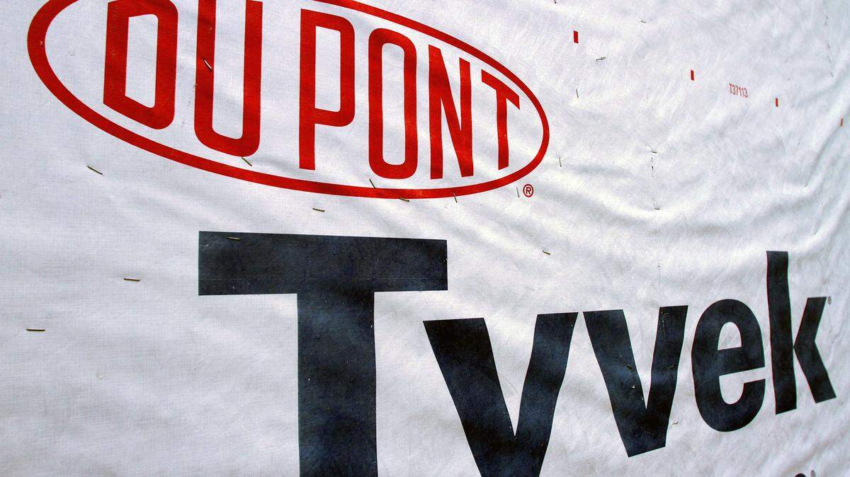 FILE - This Jan. 23, 2012, file photo, shows a DuPont logo on sheets of Tyvek insulation covering a wall of a home under construction in Springfield, Ill. Dow Chemical and the DuPont will attempt to merge in an all-stock deal that would create a colossal chemical producer worth $130 billion, before splitting into three separate companies. The deal announced Friday, Dec. 11, 2015 is being billed a merger of equals, to be called DowDuPont. (AP Photo/Seth Perlman, File)