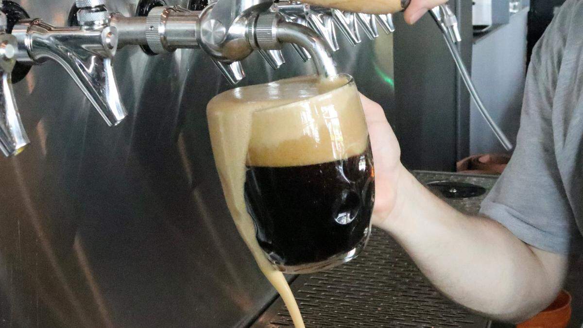 Brewmaster James Herrholz draws a Dopple Monitor Bock beer at Corporate Ladder Brewing Company.