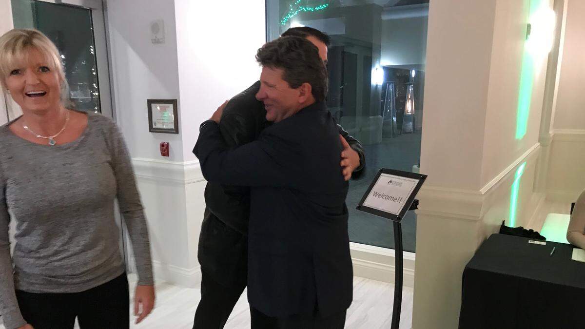 Hugh Miller, owner of the Grove restaurant, right, greets well wishers during a sneak peek of the Lakewood Ranch restaurant, which opens Monday, Dec. 10.