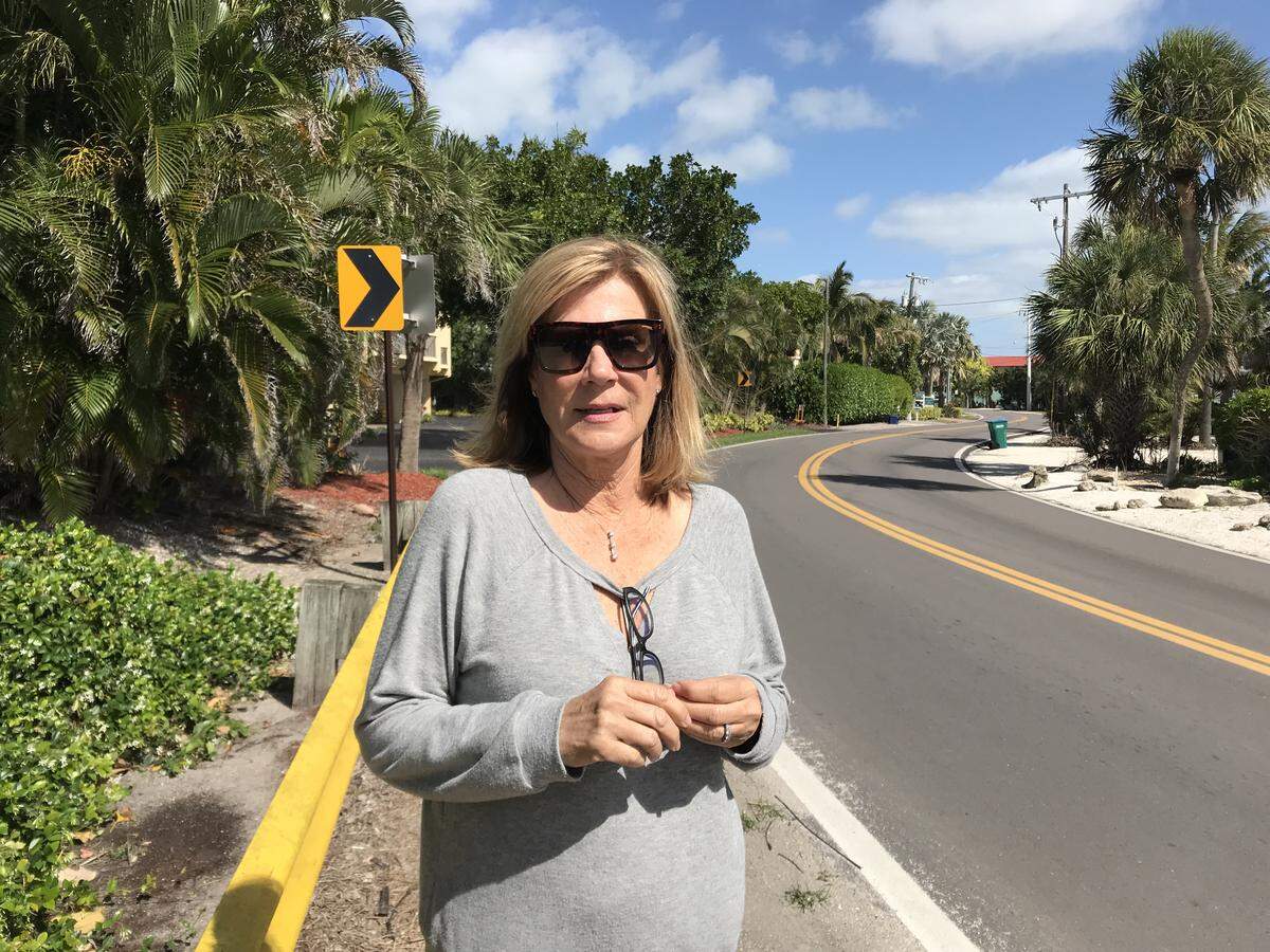 Carol Whitmore wants to retain the island charm of Holmes Beach while making traffic safer for pedestrians. She stands near an S-curve on Gulf Drive where a visitor was struck and killed in January.