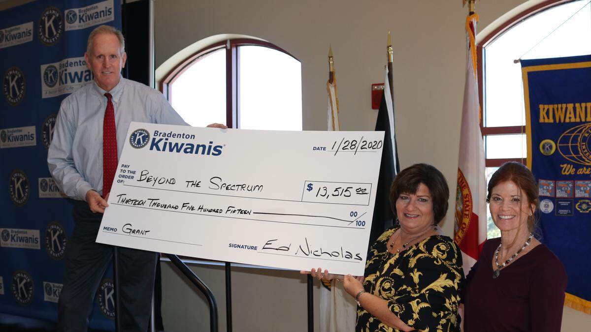 Accepting a $13,515 grant from the Bradenton Kiwanis Club for Beyond the Spectrum were Lora Carpenter and Catherine Peabody, right. Judge Ed Nicholas is shown at left.
