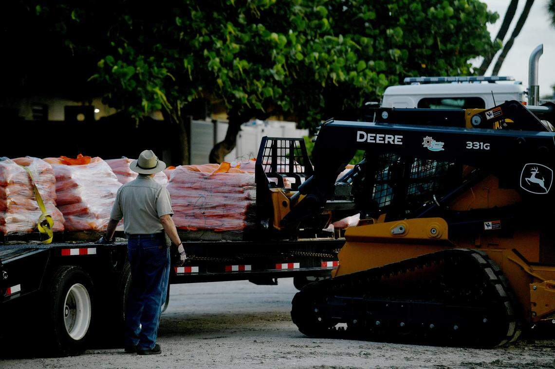 07/06/21—As Tropical Storm Elsa approaches heavy equipment unloads sandbags at Manatee Public Beach for residents to pick up.