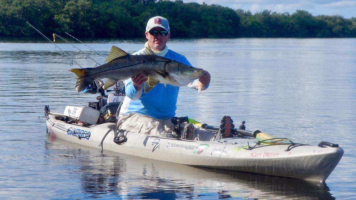 Chuck Statham shows off the 33-inch redfish that moved him into first place in the September kayak fishing tournament put on by the Hardcore Kayakers Angler Club.