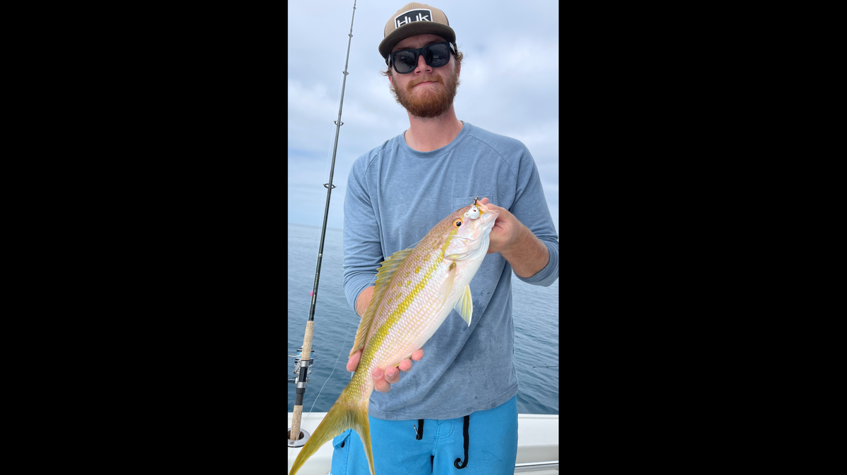 Michael Campbell poses with a yellowtail snapper caught in the Gulf of Mexico.